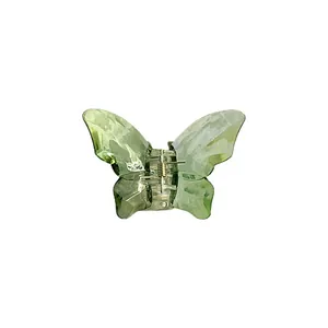 Translucent butterfly hair claw clip with mother-of-pearl finish and silver spring