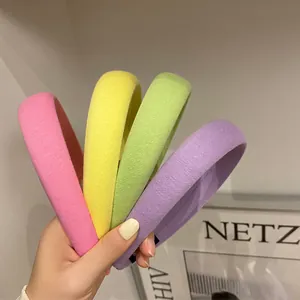 Close-up of pastel candy colored sponge headbands in pink, yellow, green and purple