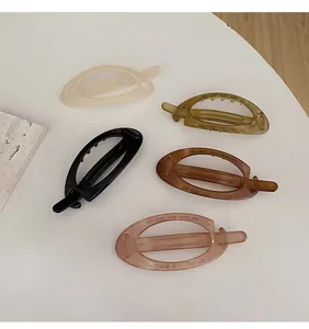 Detail of five-color oval acrylic hair clips with cutout design and non-slip teeth