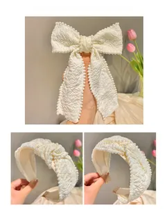 Close-up of elegant cream white pearl headband with textured fabric and oversized bow