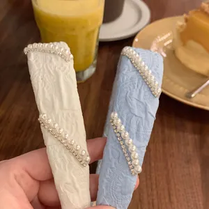 Elegant wide headband with pearls and rhinestones on blue and white jacquard fabric