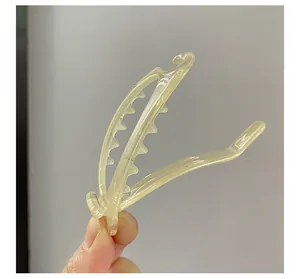Close-up of translucent yellow acrylic banana hair clip with internal teeth for secure grip
