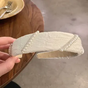Elegant wide white sponge headband with pearls and rhinestones on embossed fabric
