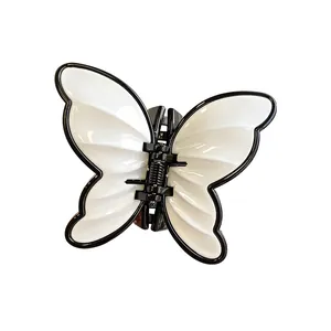 Elegant butterfly hair claw clip in black and white minimalist French style design