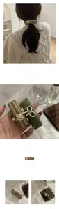 Detail of 8cm vintage camellia flower hair clip and green leather knot hairpin set