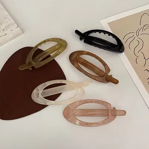 5-piece set of oval hollow acrylic banana hair clips in neutral earthy tones for women