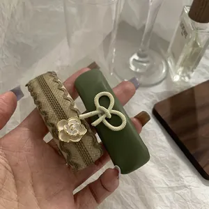 Close-up of vintage hair clips with green leather knot and white camellia flower detail