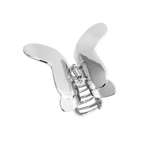 Polished silver metal butterfly hair claw clip with vintage minimalist design on white background