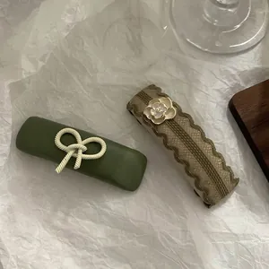 French vintage hair clip set with green ribbon bow and camellia flower ornament