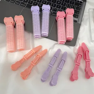 Pastel hair root volumizing rollers and alligator clips set on white fabric