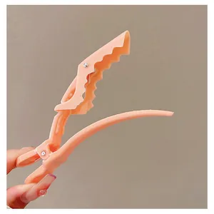 Macro view of skin-pink hair clip with wavy teeth for voluminous roots and styling