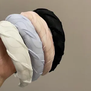 Set of four French glitter sponge headbands in cream, blue, pink and black textured fabric