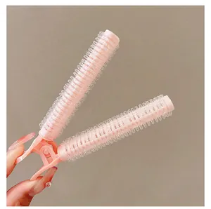 Close-up of pink hair root clip with velcro roller for volume and bangs styling