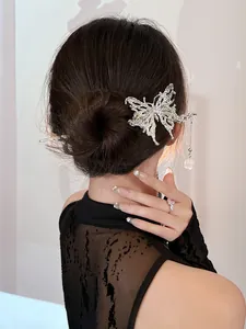 Detail of vintage silver butterfly hair pin with tassel and lily of the valley charm