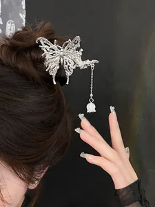 Detail of silver butterfly hair clip with lily of the valley tassel on hair