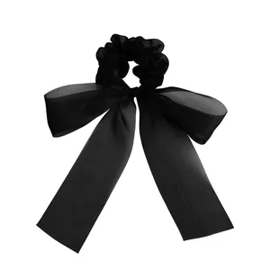 Elegant black oversized mesh bow scrunchie with long ribbons for retro hair styling