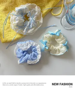 Detailed close-up of three lace and ribbon scrunchies with elegant bow designs