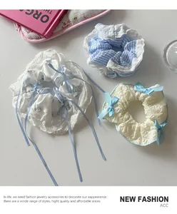 Detailed view of lace scrunchies with blue ribbons and floral patterns for girls