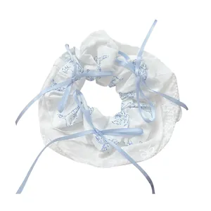 White scrunchie with blue animal prints and light blue silk ribbon bows hair accessory