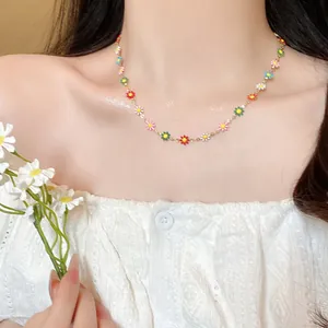 Colorful enamel daisy necklace for women featuring vibrant floral pendants on a gold chain