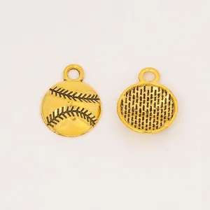 Detail of vintage baseball alloy charms in gold finish for DIY jewelry crafts