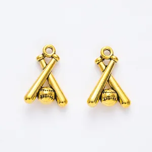 Macro shot of two vintage golden baseball and crossed bats charms with stitched texture