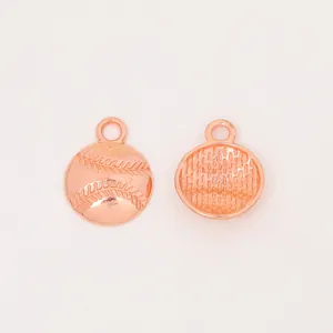 Detail of rose gold baseball charm showing textured stitch patterns and mesh back for DIY crafts