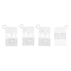 Close-up of four silver dollar bill pendants with embossed 100 digits for DIY jewelry