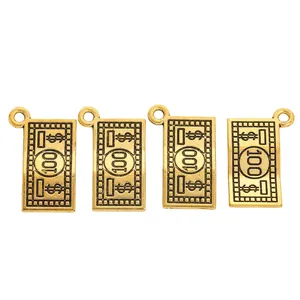 Detailed macro view of four vintage golden 100 dollar bill alloy charms for DIY jewelry