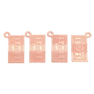 Macro detail of rose gold dollar sign charms with engraved 100 digits for DIY jewelry