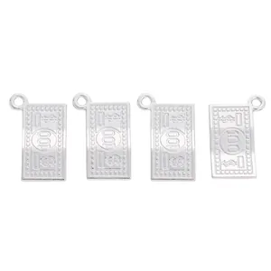 Detailed macro view of four silver alloy 100 dollar bill charms for DIY jewelry making