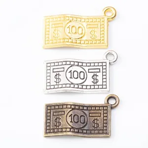 Detail view of retro dollar sign alloy charms in gold, silver, and bronze finishes