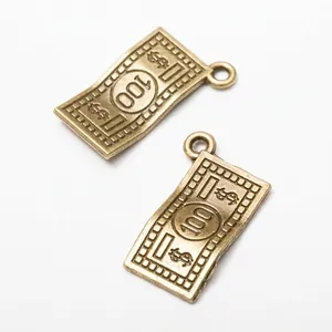 Macro detail of vintage bronze dollar bill pendants with 100 mark and sign for DIY jewelry