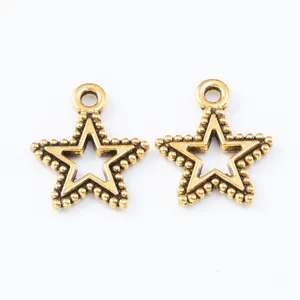 Macro detail of star-shaped hollow alloy pendants with beaded edges for DIY jewelry