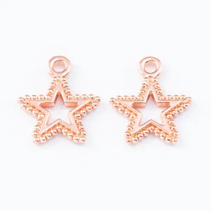 Macro detail of rose gold hollow star pendants with beaded edges and top rings