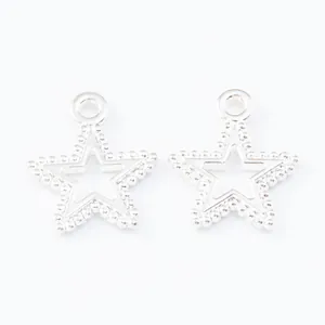 Close-up of vintage hollow star alloy pendants with beaded edge texture and top loops