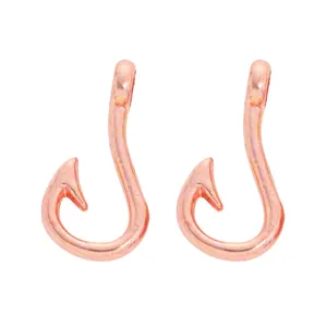 Detailed macro view of rose gold fishhook pendants with hole for DIY jewelry making