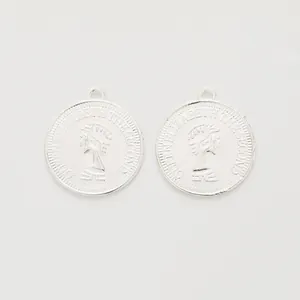 Detailed macro view of silver zinc alloy Queen Elizabeth II embossed coin charms