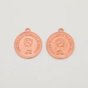 Detailed macro view of a rose gold coin pendant featuring a Queen Elizabeth relief