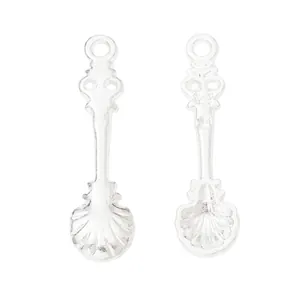 Detailed view of silver vintage spoon pendants with shell patterns for DIY jewelry making