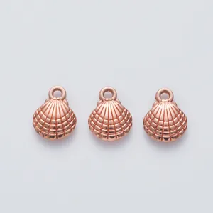Three rose gold seashell charms with detailed radial texture for DIY jewelry making