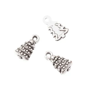 Three vintage silver zinc alloy Christmas tree pendants with DIY hanging loops on white background