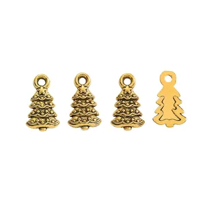 Detailed view of four golden zinc alloy Christmas tree charms for DIY jewelry making