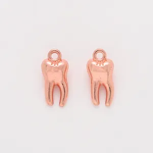 Detailed view of rose gold molar tooth alloy charms with a polished finish and top ring