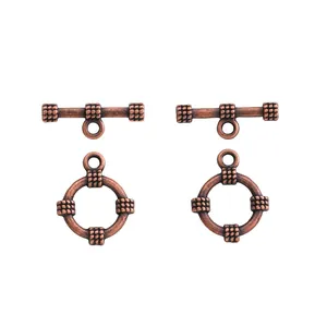 Macro detail of antique copper toggle clasps with woven texture for jewelry making