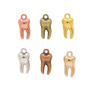 Set of 6 vintage alloy tooth-shaped pendants in various metallic finishes and colors