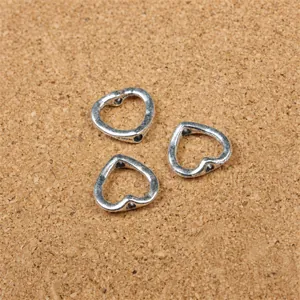 Macro view of heart-shaped vintage silver metal beads for DIY jewelry making