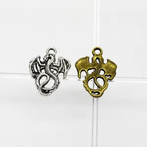Detail of vintage dragon charms in antique silver and bronze for jewelry making