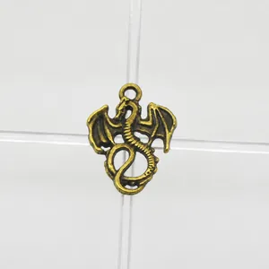 Macro shot of antique bronze dragon pendant charm with wings and ring for DIY jewelry making