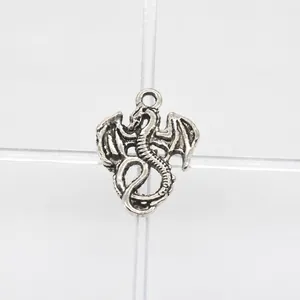 Macro shot of antique silver dragon pendant connector showing detailed wings and scales